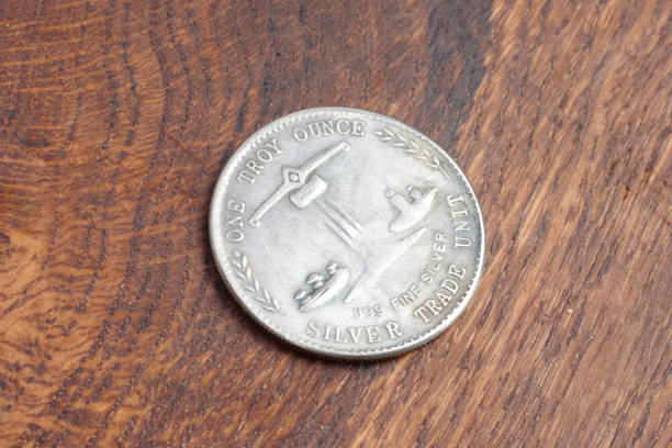 istock old vintage silver dollar on wooden background 916303770