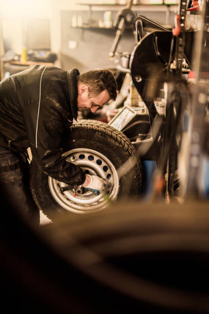 istock Mechanic putting a damaged wheel on a dyno. 916303894