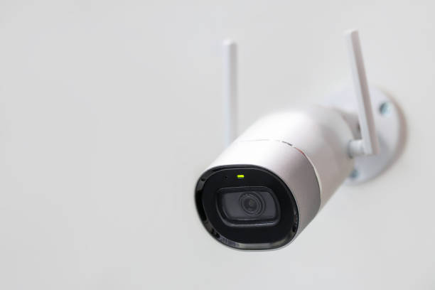 istock White surveillance camera. CCTV mounted on wall. Wifi wireless antennas enabled. Big brother watching you concept 916303908