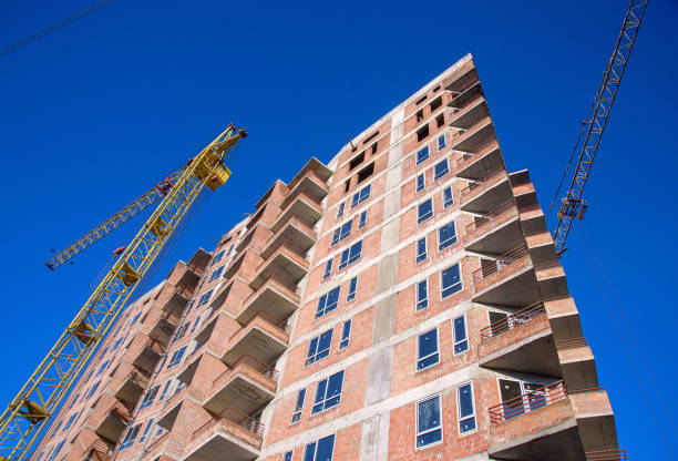 istock apartment building construction site on blue sky background 916306740