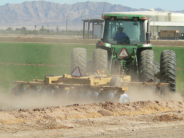 istock Woman driving tractor plowing alfalfa field 91630676
