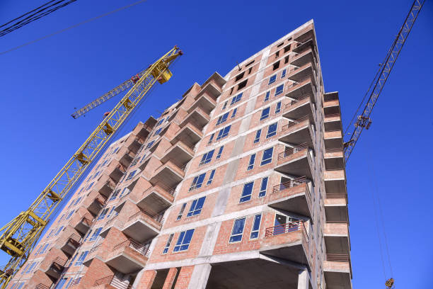 istock apartment building construction site on blue sky background 916306898
