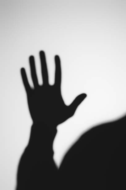 istock strange blurry shadow of human hand on grey 916307428