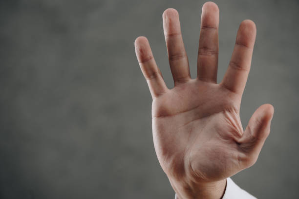istock close-up partial view of human palm on grey 916310750