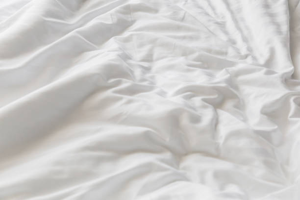 istock unmade rumpled bed with white messy pillows  in bedroom interior morning light 916314234