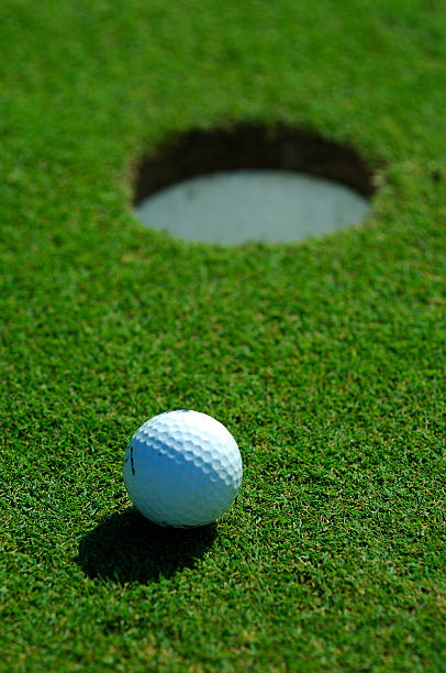 istock Golf ball close to the hole 91632150