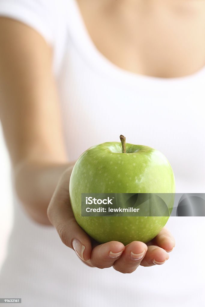 Green apple on hand  Adult Stock Photo