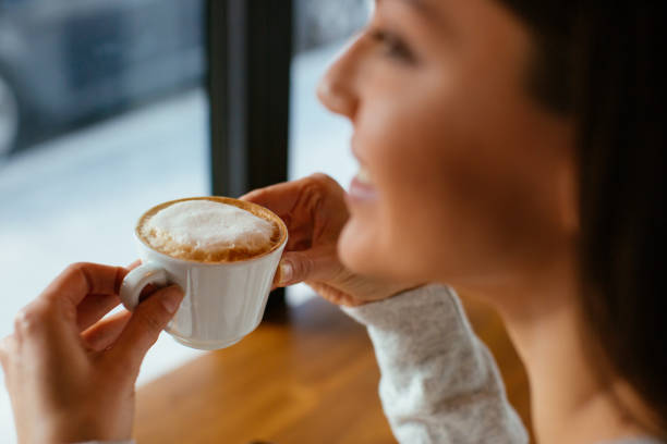 istock Woman drinking cappuccino at cafe bar 916326086
