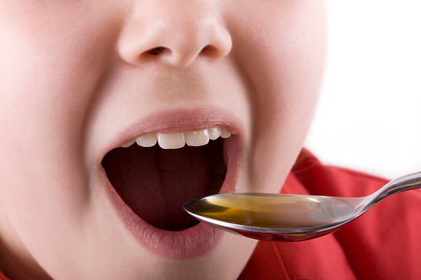istock Sick child taking medicine or cod liver oil 91632638
