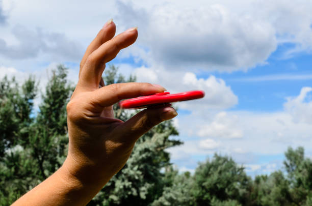 istock Red fidget spinner in female hand 916329878