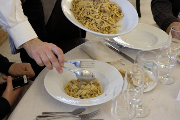 istock waiter serves pasta to the customer 916332960