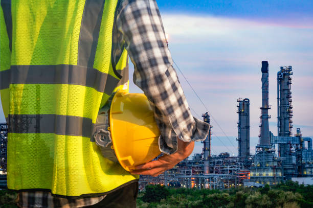 istock Engineer standing at oil refinery, Power and energy crisis concept 916333748