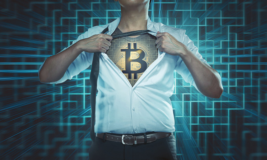 Businessman tearing his shirt open to reveal Bitcoin icon on chest with digital background