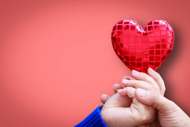 istock Human hand showing holding heart sign 916339960