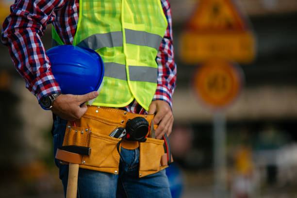 istock Close up of man holding blue helmet at construction site 916351654