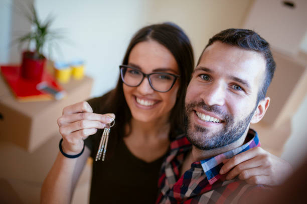 istock Young couple moving in into new apartment 916358384