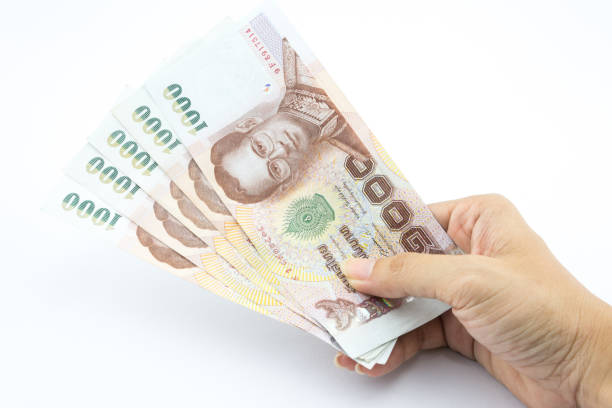 istock Thailand money in hand on a white background 916359748