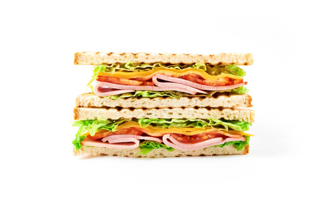 istock Sandwich with ham, cheese, tomatoes, lettuce, and toasted bread. Front view isolated on white background. 916365030