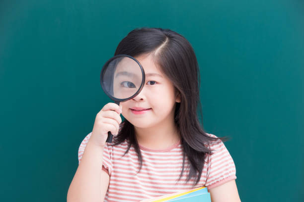 istock cute girl with green chalkboard 916379764