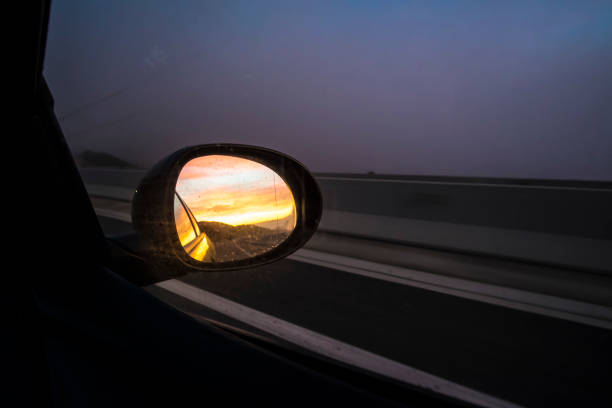 istock oval mirror car on a highway road on a dark sunset evening 916384078