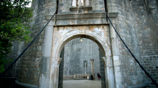POV Tourist walk through Dubrovnik entrance gate.