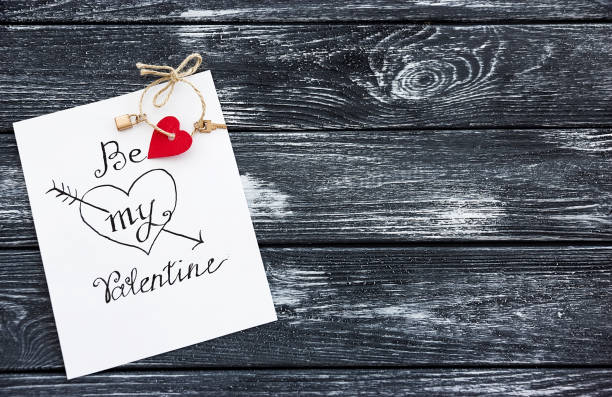 istock White mobile phone with two red hearts on the screen, invitation letter with the message 