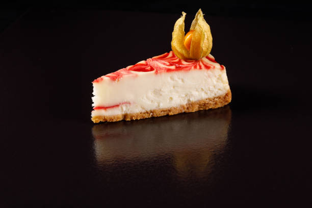 istock Exquisite strawberry cheesecake on a black background side view. 916393364
