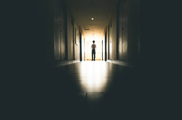istock Lone businessman walking through tunnel 916399478