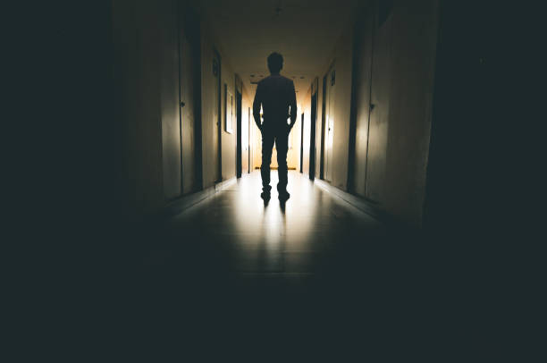 istock Lone businessman walking through tunnel 916399526