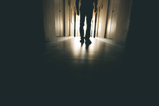 istock Lone businessman walking through tunnel 916399536