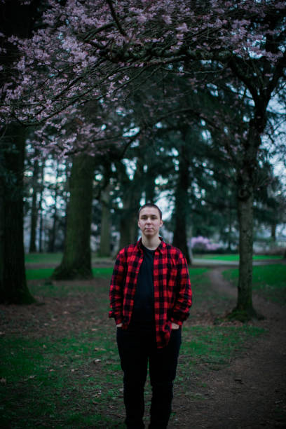 A man in the woods next to tree