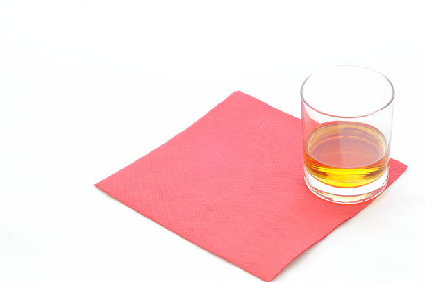 Drink on a red paper napkin, isolated on white, concept for tasting stock photo