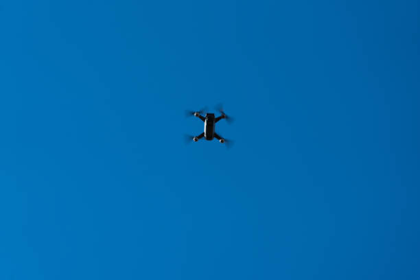 Kayseri,Türkey - December 02, 2017:Black DJI Spark quadcopter  flying into the blue sky. Low angle view.