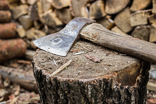 ax, hatchet, axe. split a log with an ax. birch  firewood in the background. wood wallpaper