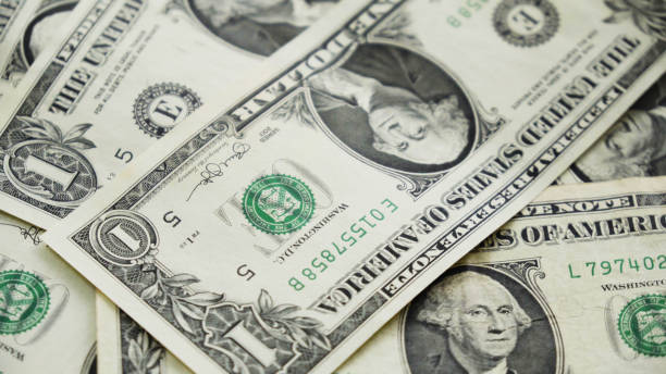 istock One dollar bills spinning on a table. Close-up 916408606