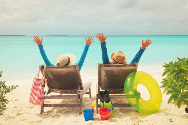 istock happy couple relax on a tropical beach 916411038