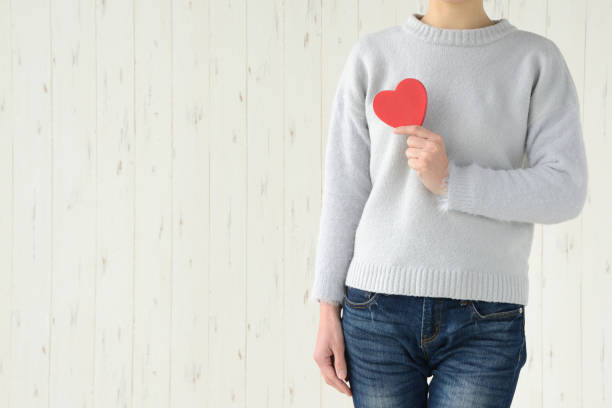 istock Woman having heart object on breast 916413866