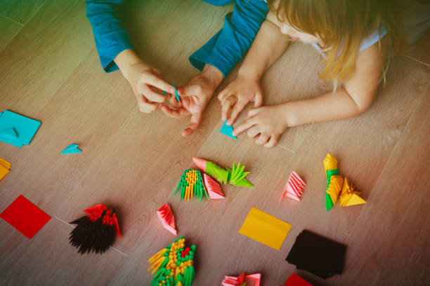 istock kids making origami crafts with paper 916414266