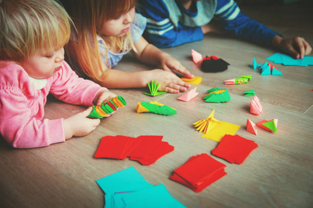 istock kids making origami crafts with paper 916414280