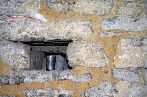 istock Niche in natural stone wall with tin cup 916414658