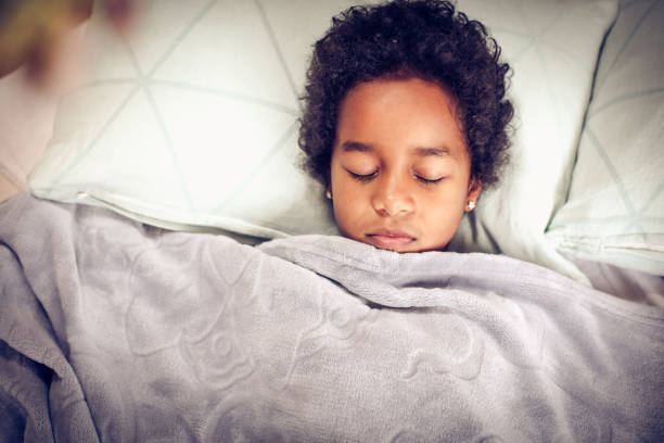 istock Portrait little girl in bed. 916417678