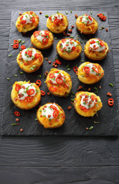 istock baked potatoes loaded with grated cheese 916417900