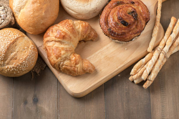 istock Homemade croissant and bread on old wood 916419148