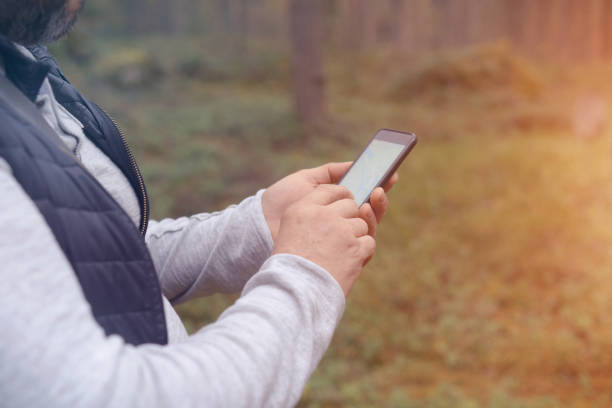 istock Male hand holding mobile phone 916421638