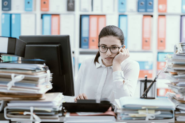 bored office worker sitting at desk - office stationary paper ring binder imagens e fotografias de stock