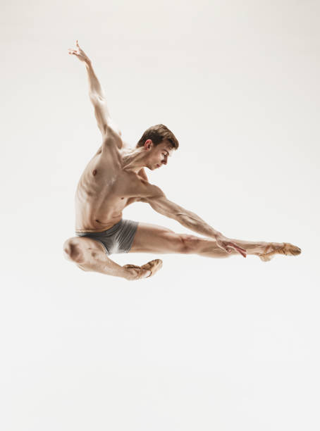 istock The male athletic ballet dancer performing dance isolated on white background 916425546