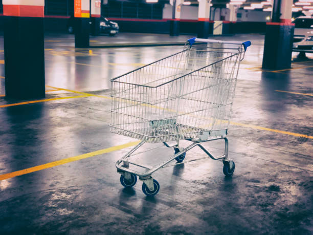 istock Empty supermarket cart stopped in parking lot. 916428232