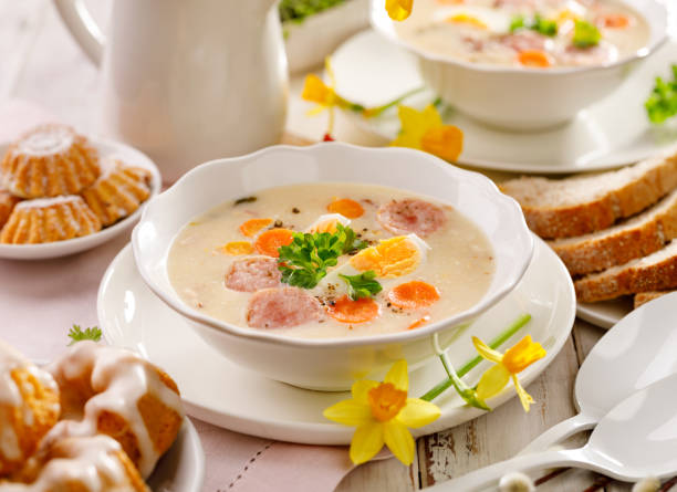 White borscht, polish Easter soup with the addition of white sausage and a hard boiled egg in a ceramic bowl White borscht, polish Easter soup with the addition of white sausage and a hard boiled egg in a ceramic bowl. Traditional Easter dish in Poland weisswurst photos stock pictures, royalty-free photos & images