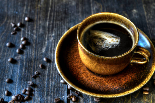 istock Cup of black coffee on a wooden table 916430364