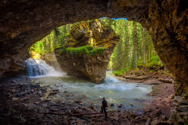 istock Hiker watching Johnston Creek from a cave 916433702